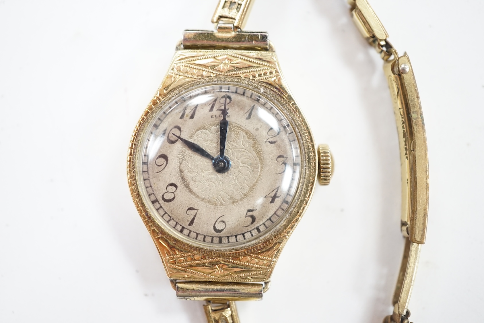 A lady's 14k manual wind wrist watch, with Arabic dial and engraved case, on a gold plated bracelet. Condition - poor